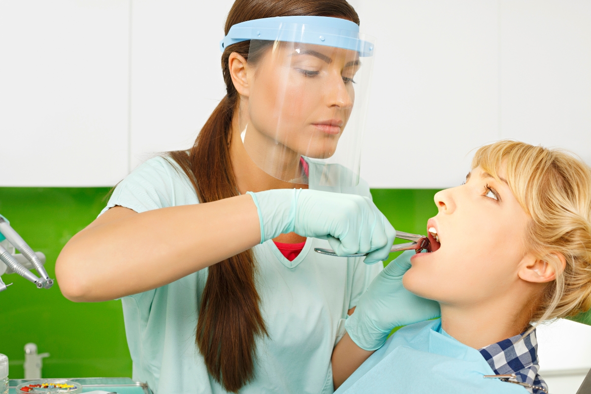 Pediatric dentist providing emergency dental care to a child patient at a family dentistry clinic in Forest Hill